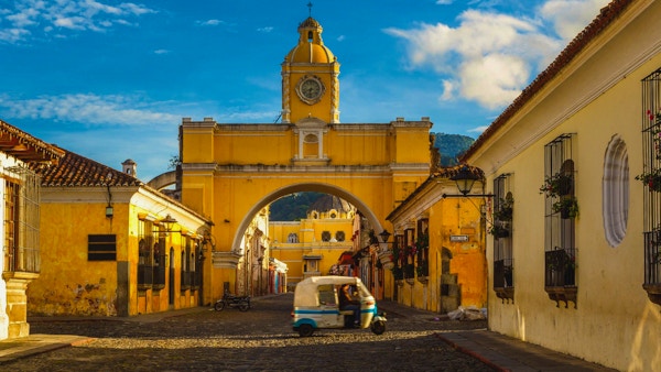 en tuk-tuk-taxi passerer inn fra Santa Archina-buen i Antigua, Guatemala.