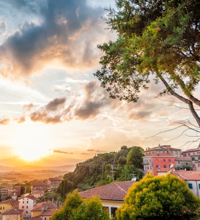 Chiusi solnedgangskveld i Umbria, Italia med takhus på fjellandskap bølgende åser og fargerik pittoreske bybildesol