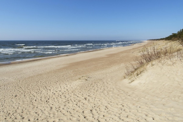 En vakker sandstrand på en solfylt ettermiddag i Palanga, Litauen
