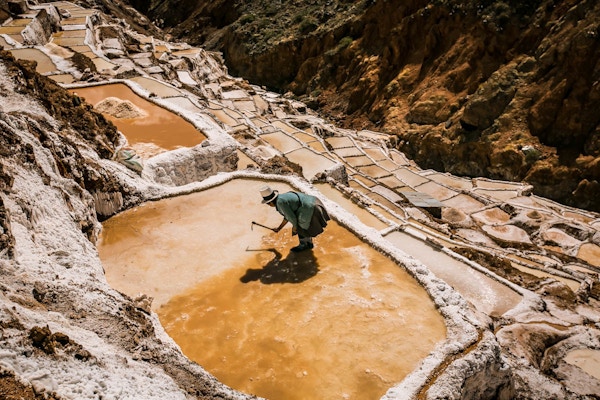 En dame som jobber i saltbassenget i Maras