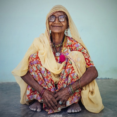 Eldre kvinne som smiler til kameraet