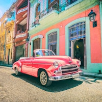 Vintage rosa oldtimer bil kjører gjennom gamle Havana Cuba