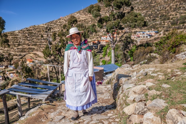 Aymara-kvinne som går på Isla del Sol (Island of the Sun), Titicacasjøen, Bolivia. Isla del Sol er en øy i den sørlige delen av Titicacasjøen. Det er en del av den moderne flernasjonale staten Bolivia. Geografisk er terrenget hardt; det er en steinete, kupert øy. Det er ingen motorkjøretøyer eller asfalterte veier på øya. Den viktigste økonomiske aktiviteten til de rundt 800 familiene på øya er jordbruk, med fiske og turisme som forsterker livsoppholdsøkonomien. Av flere landsbyer er Yumani og Cha'llapampa de største. Det er over 80 ruiner på øya. De fleste av disse dateres til inkaperioden rundt 1400-tallet e.Kr. Arkeologer har oppdaget bevis på at folk bodde på øya så langt tilbake som det tredje årtusen fvt. Mange åser på øya inneholder jordbruksterrasser, som tilpasser bratt og steinete terreng til jordbruk. Blant ruinene på øya er Sacred Rock, en labyrintlignende bygning kalt Chicana, Kasa Pata og Pilco Kaima. I religionen til inkaene trodde man at solguden ble født her.