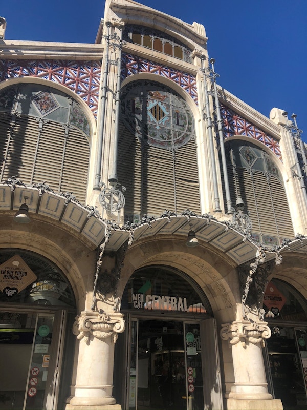 Inngang til markedet i Valencia med glassvinduer og utsmykninger over